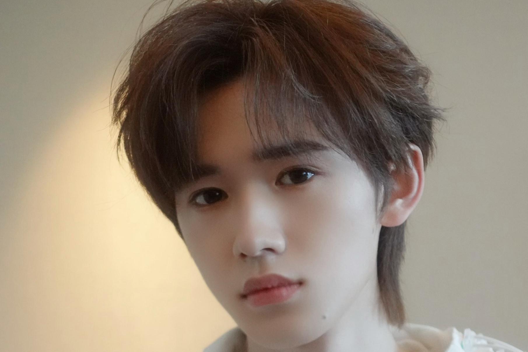 宋亚轩分享工作生活小乐趣 宋亚轩身穿白色衬衫,头发微卷,笑容阳光